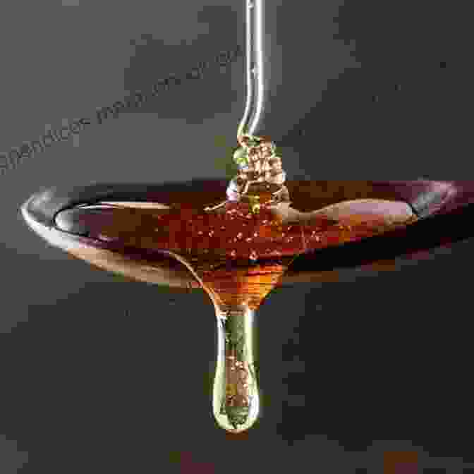 Honey Being Poured Into A Spoon For Cough Suppression 34 Uses For Honey (Natural Health 1)